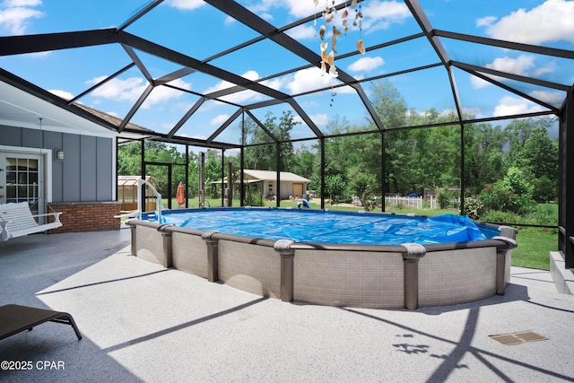 16532 SW Mimosa St, Blountstown, FL 32424 - swimming pool with a patio, glass enclosure, and view of wooded area