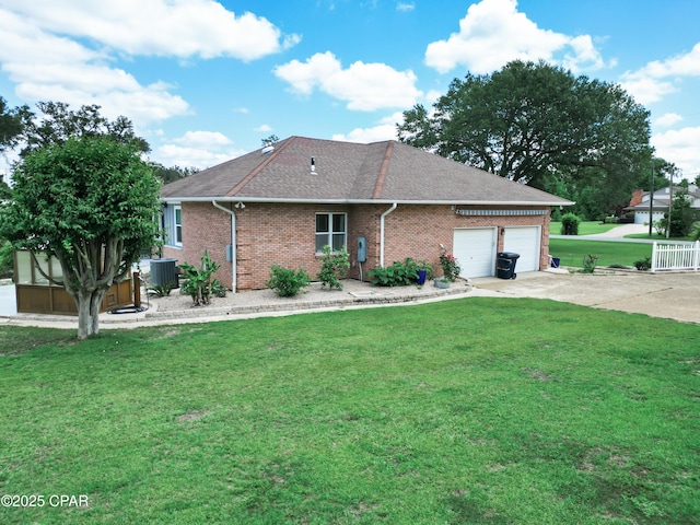 16532 SW Mimosa St, Blountstown, FL 32424 - back of property with brick siding, driveway, a yard, a shingled roof, and a garage