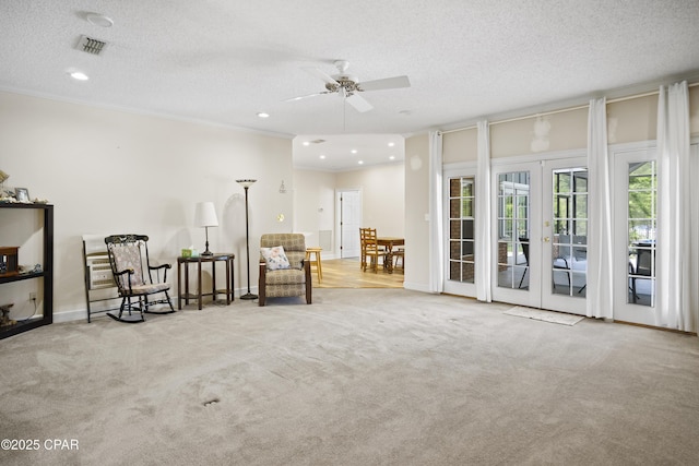 16532 SW Mimosa St, Blountstown, FL 32424 - sitting room featuring french doors, a textured ceiling, ornamental molding, a ceiling fan, and carpet