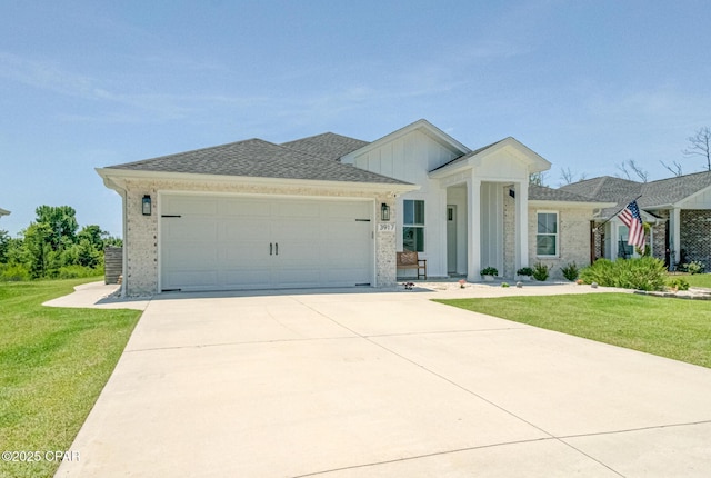 3917 Sandpine Way, Panama City, FL 32404 - view of front of house featuring a front lawn, a garage, concrete driveway, and brick siding
