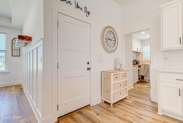 3917 Sandpine Way, Panama City, FL 32404 - entrance foyer with built in desk, light wood finished floors, healthy amount of natural light, and baseboards