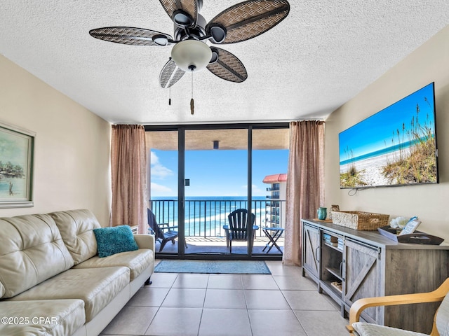 6505 Thomas Dr Unit 1009B, Panama City Beach, FL 32408 - tiled living area with expansive windows, a textured ceiling, and a ceiling fan