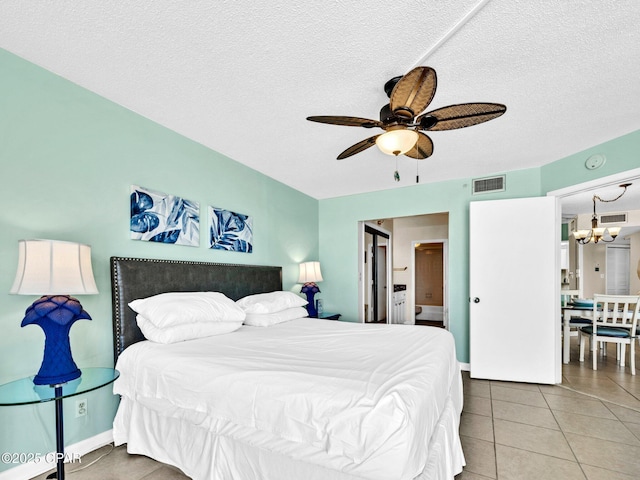 6505 Thomas Dr Unit 1009B, Panama City Beach, FL 32408 - bedroom with a chandelier, a textured ceiling, tile patterned floors, and a ceiling fan