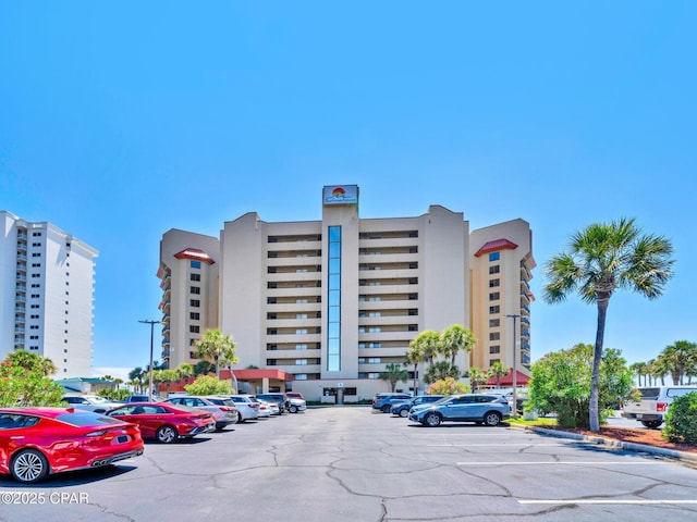6505 Thomas Dr Unit 1009B, Panama City Beach, FL 32408 - view of building exterior featuring uncovered parking