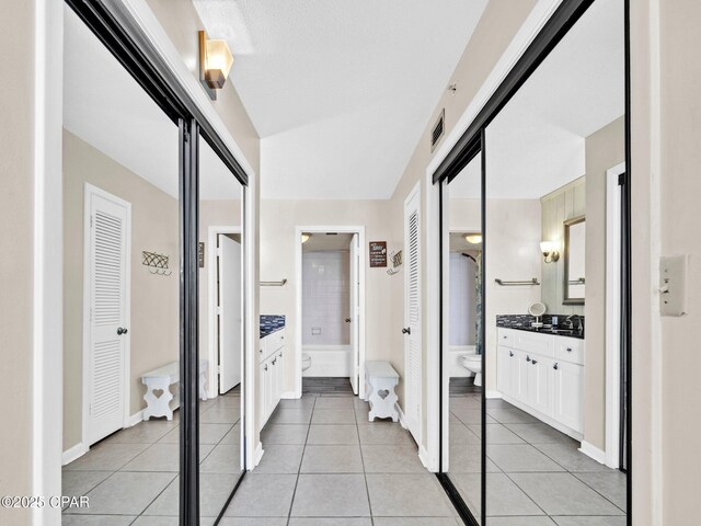 6505 Thomas Dr Unit 1009B, Panama City Beach, FL 32408 - corridor featuring light tile patterned flooring, a sink, and baseboards