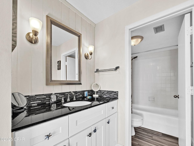 6505 Thomas Dr Unit 1009B, Panama City Beach, FL 32408 - full bathroom with toilet, wood finished floors, vanity, and shower / washtub combination