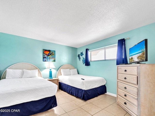 6505 Thomas Dr Unit 1009B, Panama City Beach, FL 32408 - bedroom featuring a textured ceiling and light tile patterned flooring