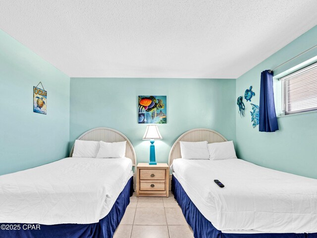 6505 Thomas Dr Unit 1009B, Panama City Beach, FL 32408 - bedroom with light tile patterned floors and a textured ceiling