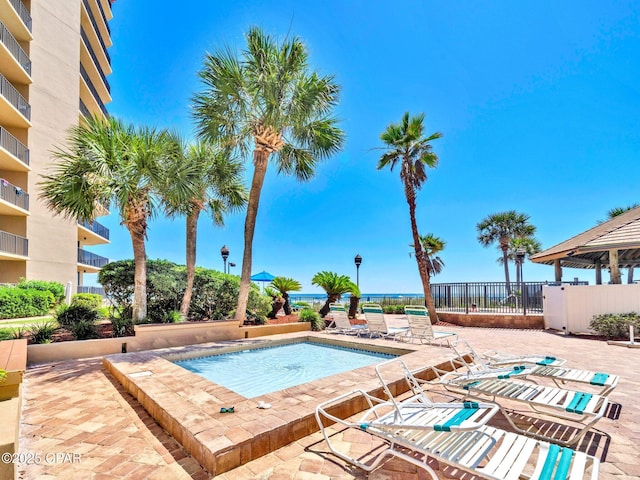 6505 Thomas Dr Unit 1009B, Panama City Beach, FL 32408 - view of swimming pool featuring a community hot tub, a patio, and fence