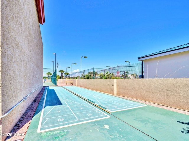 6505 Thomas Dr Unit 1009B, Panama City Beach, FL 32408 - view of community featuring fence and shuffleboard