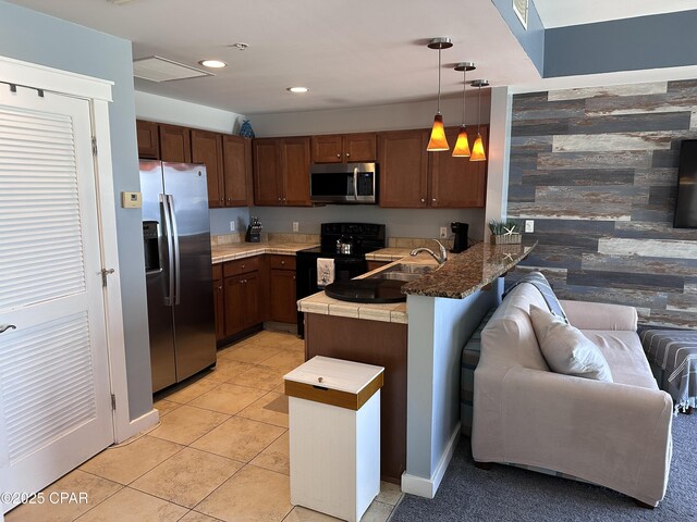 15100 Front Beach Rd Unit 1416, Panama City Beach, FL 32413 - kitchen featuring appliances with stainless steel finishes, a peninsula, open floor plan, decorative light fixtures, and a sink