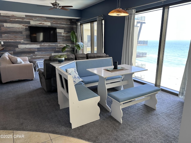 15100 Front Beach Rd Unit 1416, Panama City Beach, FL 32413 - dining room featuring plenty of natural light, carpet floors, a ceiling fan, wooden walls, and an accent wall