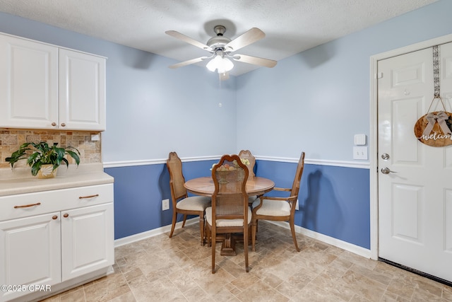 1402 New Hampshire Ave, Lynn Haven, FL 32444 - dining area featuring baseboards, a ceiling fan, a textured ceiling, and stone finish flooring