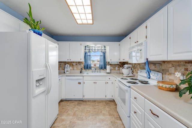 1402 New Hampshire Ave, Lynn Haven, FL 32444 - kitchen with white appliances, backsplash, white cabinets, stone finish floors, and light countertops