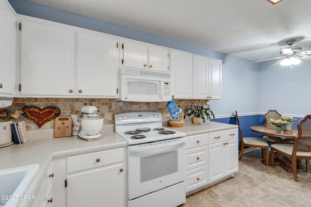1402 New Hampshire Ave, Lynn Haven, FL 32444 - kitchen with white appliances, light countertops, a ceiling fan, backsplash, and white cabinets