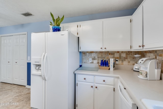 1402 New Hampshire Ave, Lynn Haven, FL 32444 - kitchen with white appliances, light countertops, decorative backsplash, and white cabinetry