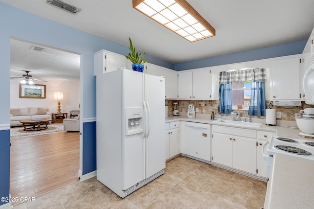 1402 New Hampshire Ave, Lynn Haven, FL 32444 - kitchen featuring white appliances, a sink, backsplash, light countertops, and ceiling fan