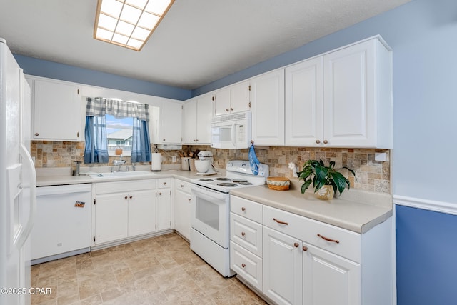 1402 New Hampshire Ave, Lynn Haven, FL 32444 - kitchen featuring white appliances, a sink, tasteful backsplash, white cabinets, and light countertops