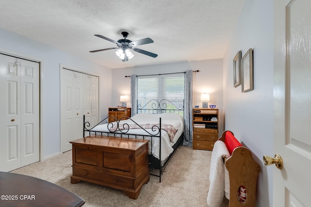 1402 New Hampshire Ave, Lynn Haven, FL 32444 - bedroom with multiple closets, light carpet, ceiling fan, and a textured ceiling