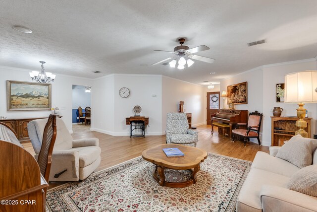 1402 New Hampshire Ave, Lynn Haven, FL 32444 - living area with a chandelier, light wood finished floors, a ceiling fan, crown molding, and baseboards