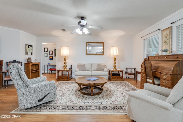 1402 New Hampshire Ave, Lynn Haven, FL 32444 - living area featuring crown molding, a ceiling fan, and light wood-style floors