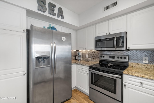 14701 Front Beach Rd Unit 1735, Panama City Beach, FL 32413 - kitchen featuring appliances with stainless steel finishes, decorative backsplash, and white cabinets