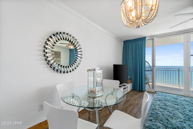 14701 Front Beach Rd Unit 1735, Panama City Beach, FL 32413 - dining space featuring expansive windows, wood finished floors, crown molding, and a chandelier