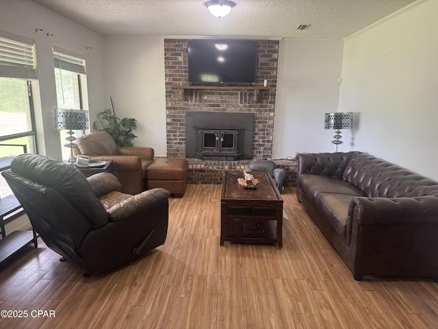 3120 Bonnett Pond Rd, Chipley, FL 32428 - living room featuring wood finished floors, a textured ceiling, and a fireplace
