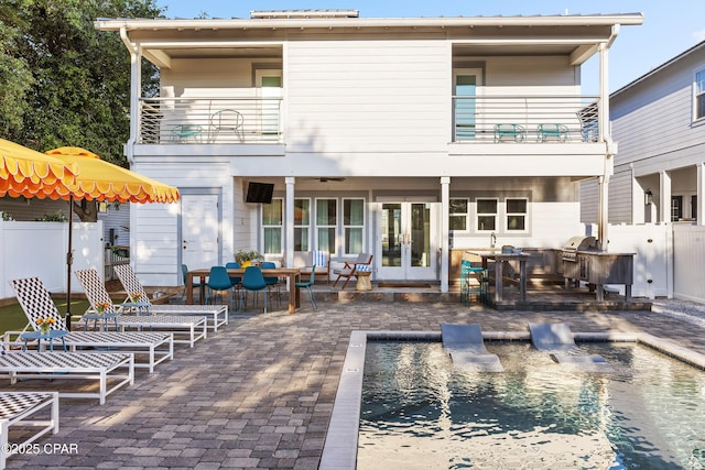 98 Shirah St, Destin, FL 32541 - back of house with a balcony, area for grilling, a patio, an outdoor pool, and french doors