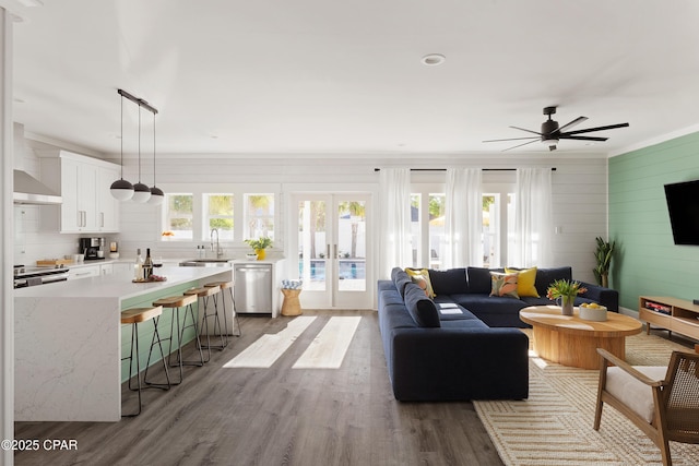 98 Shirah St, Destin, FL 32541 - living area featuring crown molding, wood finished floors, ceiling fan, french doors, and wood walls