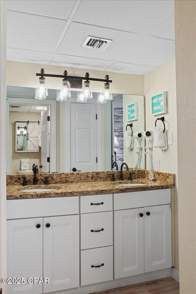 11757 Front Beach Rd Unit W601, Panama City Beach, FL 32407 - bathroom with double vanity and wood finished floors