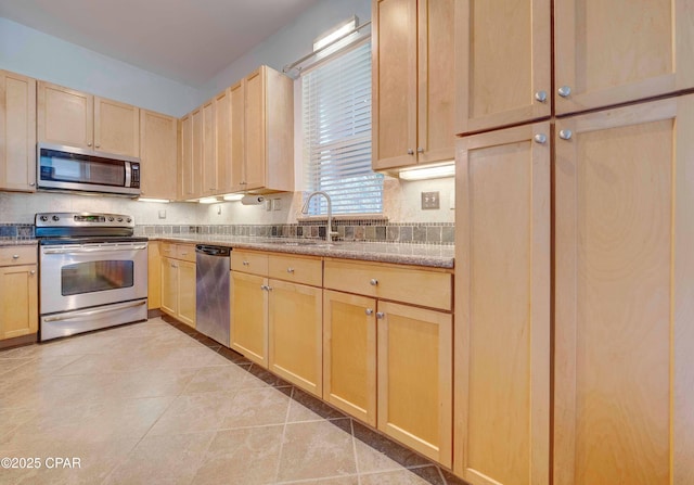 8700 Front Beach Rd Unit 7101, Panama City Beach, FL 32407 - kitchen featuring appliances with stainless steel finishes, light brown cabinets, a sink, and tasteful backsplash