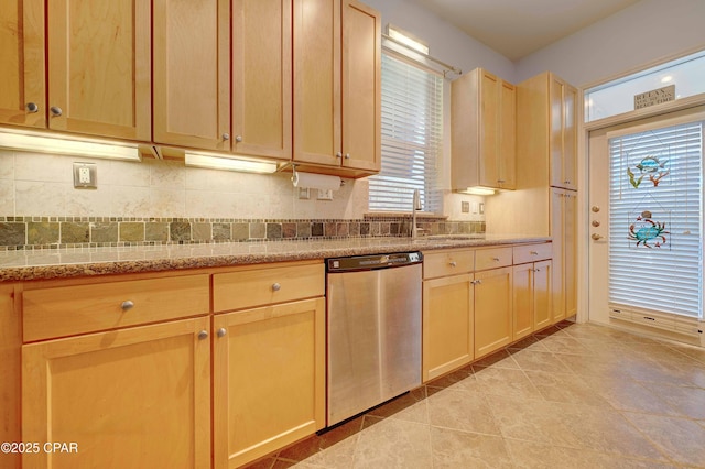 8700 Front Beach Rd Unit 7101, Panama City Beach, FL 32407 - kitchen featuring stainless steel dishwasher, a sink, light tile patterned floors, light stone countertops, and decorative backsplash