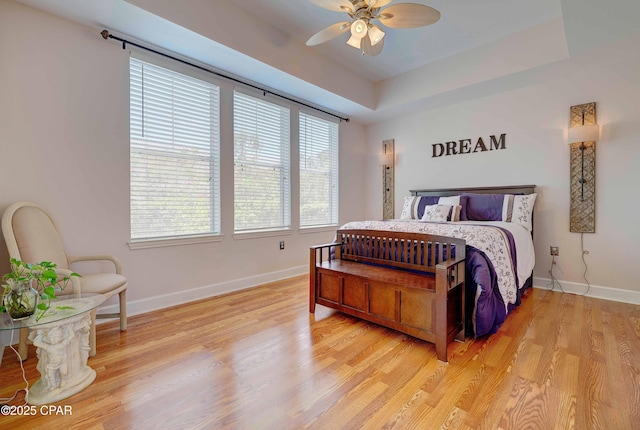 8700 Front Beach Rd Unit 7101, Panama City Beach, FL 32407 - bedroom featuring baseboards, light wood-type flooring, a ceiling fan, and a raised ceiling
