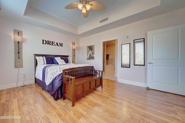 8700 Front Beach Rd Unit 7101, Panama City Beach, FL 32407 - bedroom featuring a tray ceiling, baseboards, light wood-style flooring, and a ceiling fan