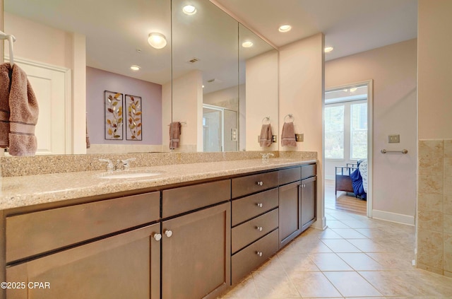8700 Front Beach Rd Unit 7101, Panama City Beach, FL 32407 - ensuite bathroom featuring double vanity, tile patterned flooring, a stall shower, and baseboards