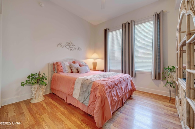 8700 Front Beach Rd Unit 7101, Panama City Beach, FL 32407 - bedroom featuring light wood finished floors, multiple windows, baseboards, and a ceiling fan