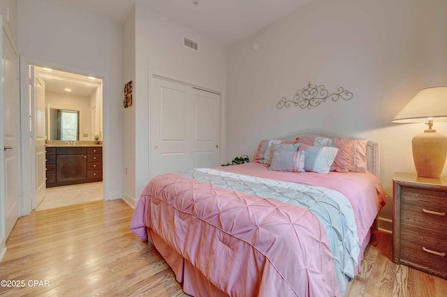 8700 Front Beach Rd Unit 7101, Panama City Beach, FL 32407 - bedroom with light wood-style flooring, a closet, baseboards, and ensuite bath