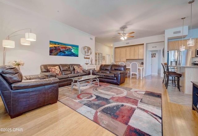8700 Front Beach Rd Unit 7101, Panama City Beach, FL 32407 - living room with light wood-style flooring, a ceiling fan, and crown molding