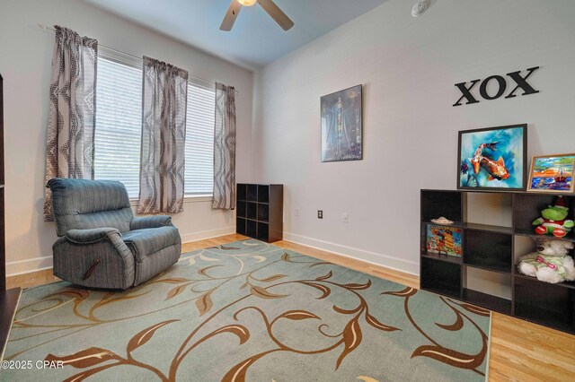 8700 Front Beach Rd Unit 7101, Panama City Beach, FL 32407 - living area featuring ceiling fan, wood finished floors, and baseboards