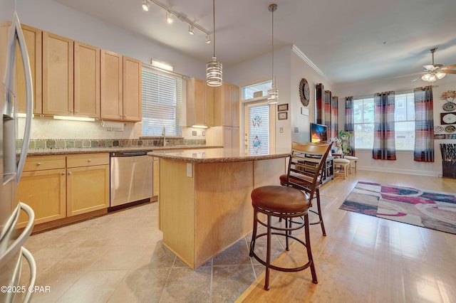 8700 Front Beach Rd Unit 7101, Panama City Beach, FL 32407 - kitchen with appliances with stainless steel finishes, a kitchen island, light brown cabinetry, a ceiling fan, and ornamental molding