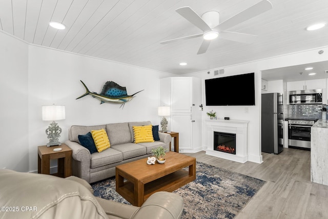 9850 S Thomas Dr Unit 1112E, Panama City Beach, FL 32408 - living area with wood ceiling, light wood-style floors, recessed lighting, ceiling fan, and a glass covered fireplace