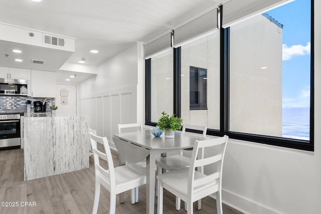 9850 S Thomas Dr Unit 1112E, Panama City Beach, FL 32408 - dining space with light wood-type flooring and recessed lighting