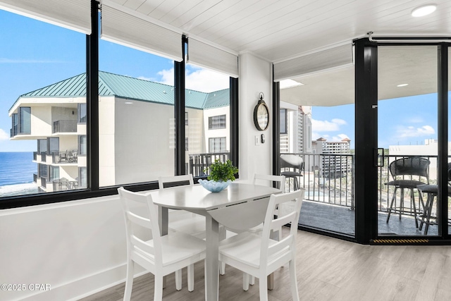 9850 S Thomas Dr Unit 1112E, Panama City Beach, FL 32408 - dining room with wood finished floors, a wall of windows, and healthy amount of natural light