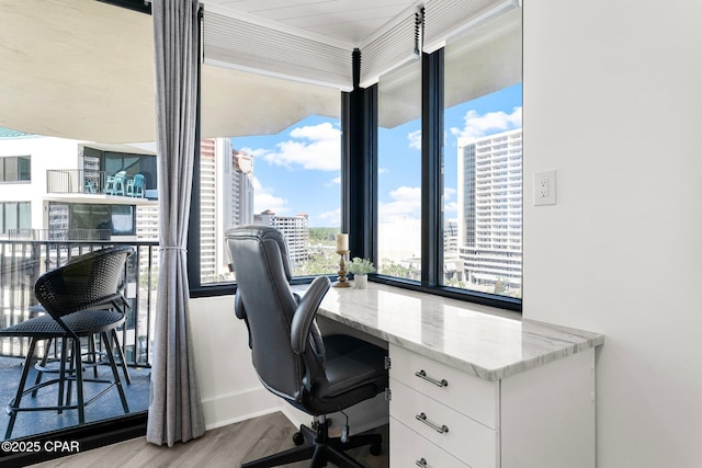 9850 S Thomas Dr Unit 1112E, Panama City Beach, FL 32408 - office area with wood finished floors, floor to ceiling windows, a view of city, built in desk, and baseboards