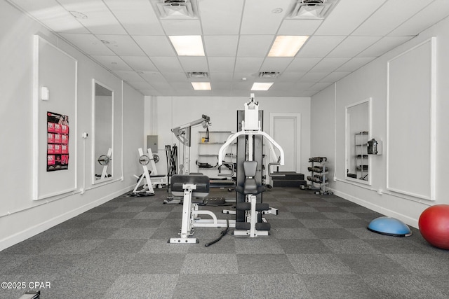 9850 S Thomas Dr Unit 1112E, Panama City Beach, FL 32408 - workout room featuring a paneled ceiling and dark colored carpet