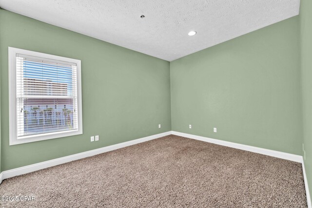 216 Bonita Cir Unit C, Panama City, FL 32408 - unfurnished room with baseboards, carpet floors, a textured ceiling, and recessed lighting