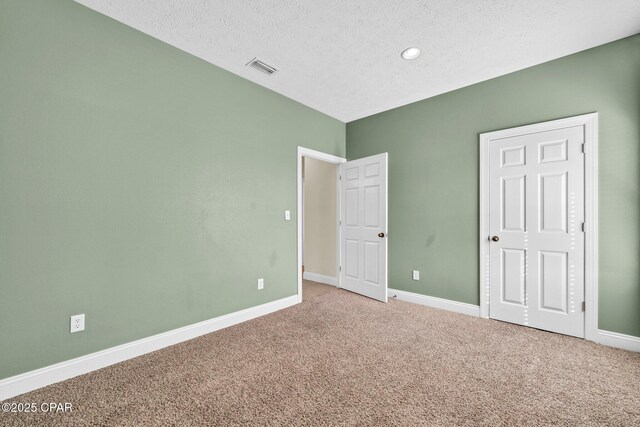 216 Bonita Cir Unit C, Panama City, FL 32408 - unfurnished bedroom with carpet flooring, baseboards, and a textured ceiling