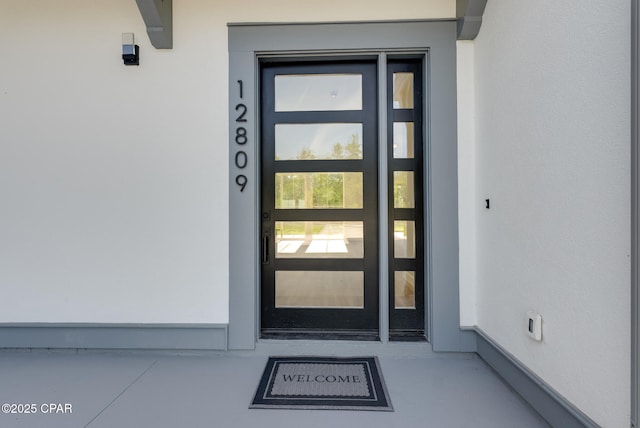 12809 Merial Green Way, Southport, FL 32409 - entrance to property with stucco siding