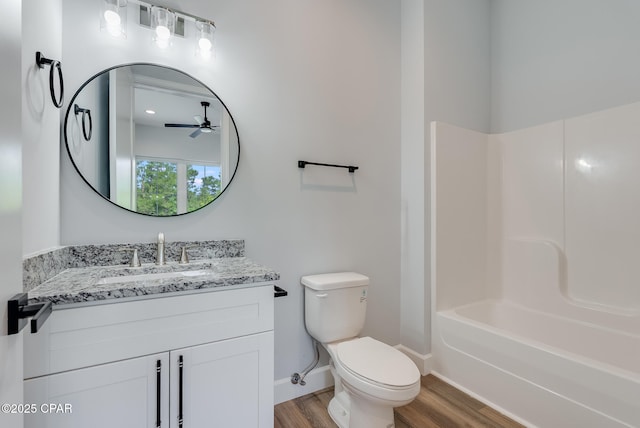 12809 Merial Green Way, Southport, FL 32409 - full bath with wood finished floors, toilet, ceiling fan, vanity, and baseboards